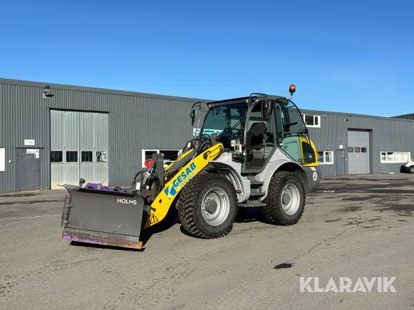 Hjullastare Kramer 8115 med vikplog, planeringsskopa och hydrauliska gafflar