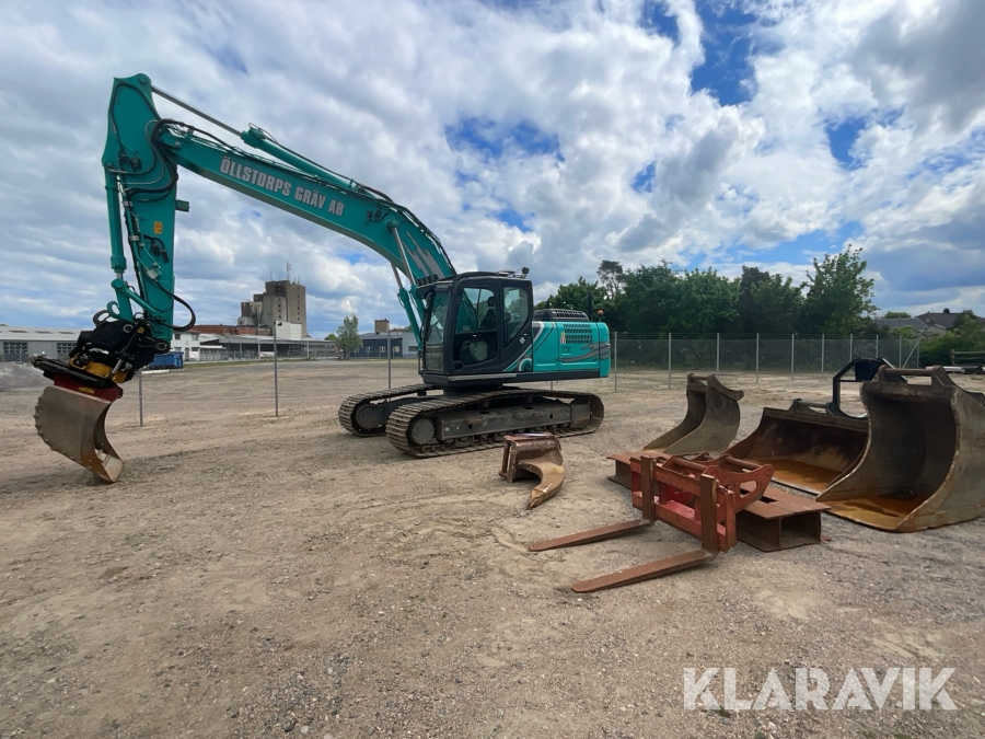 Bandgrävmaskin Kobelco SK210LC-10E med grävsystem och många redskap